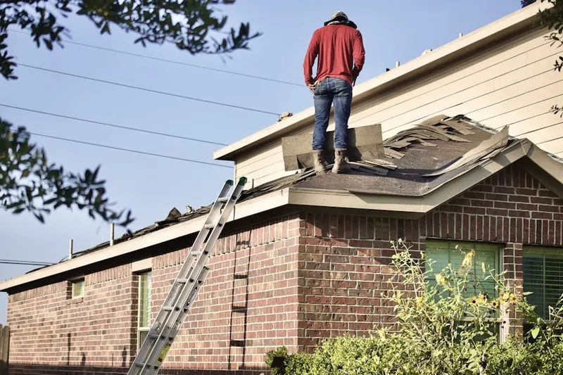 Professional roofer working on a residential roof in King Corners